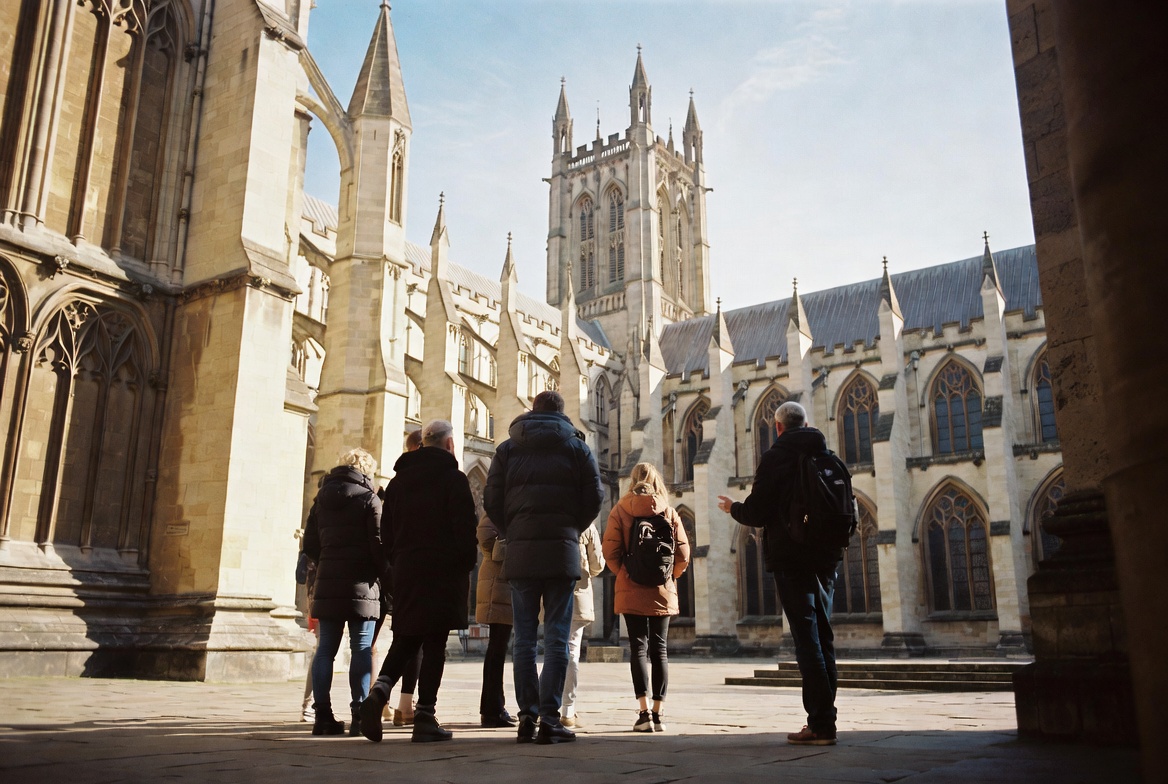 A small group on a Abbey Creed Tour at the gates of Southwark Cathedral.